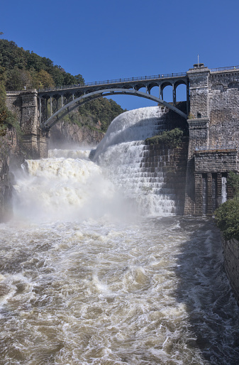 croton reservoir dam with bridge (natural and artifical waterfall in westchester, upstate new york) heavy flow of water