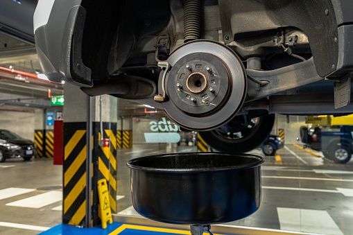 Close up view of a Maintenance Car service - auto oil change, motor check, brake cleaning, tire check, engine inspection, motor oil-brake inspection