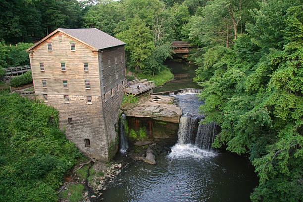 Lanterman's Mill - Youngstown, Ohio "Lanterman's Mill.  Mill Creek Park, Youngstown, Ohio.  Includes water falls and covered bridge behind.See more of my" watermill stock pictures, royalty-free photos & images