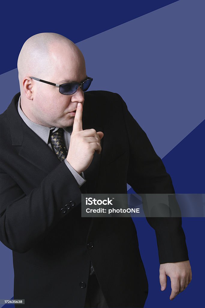 Shhhh! "Hitman type figure saying, Shhh!" Balding Stock Photo