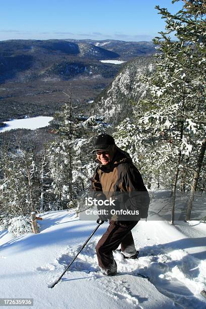 Senior Man Walking In Snowshoe Trail In Winter Stock Photo - Download Image Now - 55-59 Years, Active Lifestyle, Active Seniors