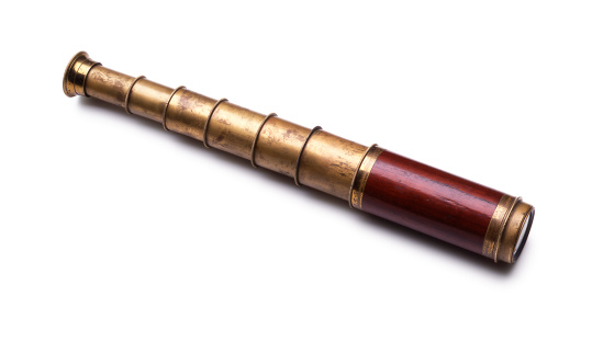Antique spyglass shot on white background with soft shadow.