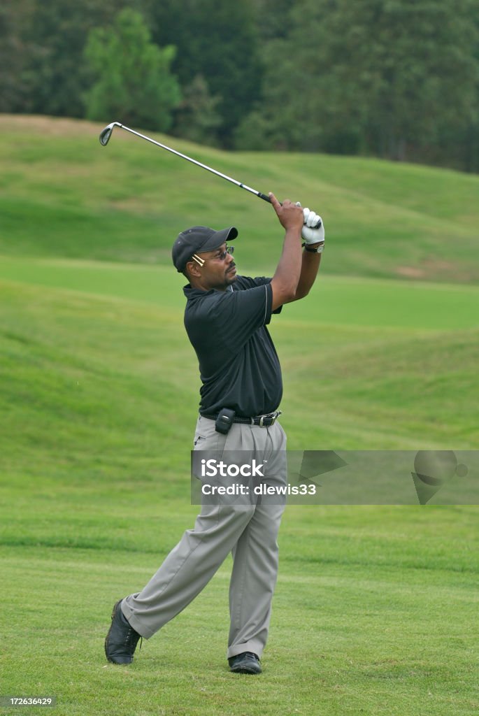 Golfer Golfer following through on a swing. Need photos representing golf African Ethnicity Stock Photo