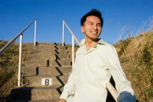 Happy Asian male looking out at the hills on a sunny day and smiling. CLICK FOR SIMILAR IMAGES AND LIGHTBOX WITH MORE MEN.