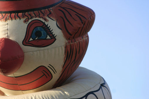 inflatable clownaas head against blue sky... see my metaphor