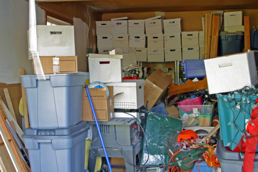 Garage with clutter and storage boxes.