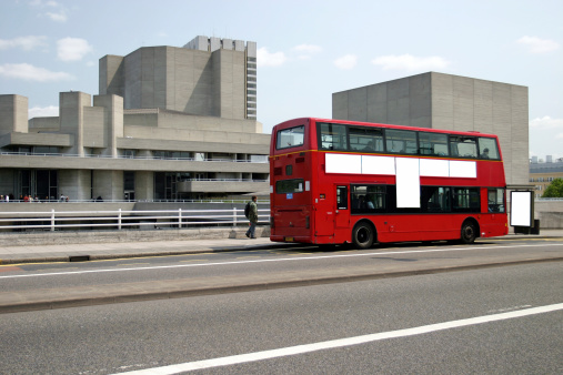 A red London bus with blank advertising space. Clipping path.