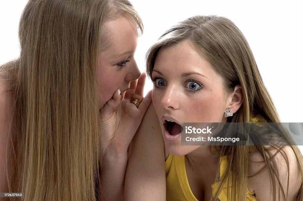 Secrets and Gossip Two young women telling secrets Adult Stock Photo