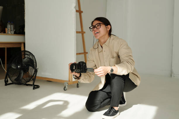 istock Happy young photographer with photocamera communicating with model 1726379792