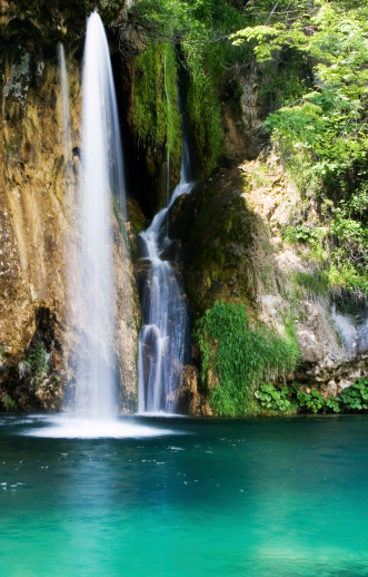 A tranquile blue mountain lake with gorgeous waterfalls.