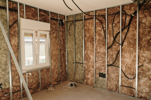 A house under renovation, isolating a wall with fiberglass