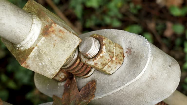 Bolted suspension bridge fastener with rusty corroded nuts. Close up