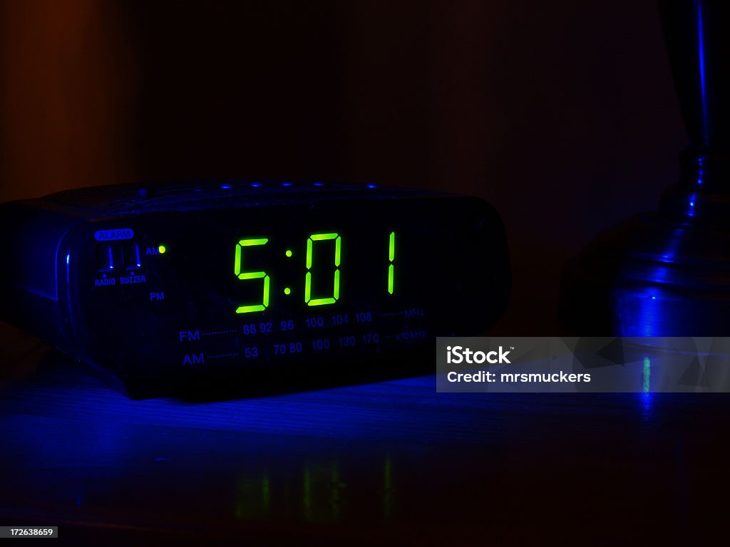 501 displayed on a clock in a dark room A digital alarm clock with a reading of 5:01 AM.   Alarm Clock Stock Photo