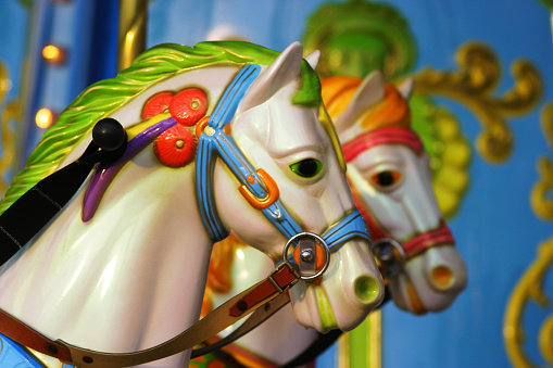 Two fairground ride horses at a funfair