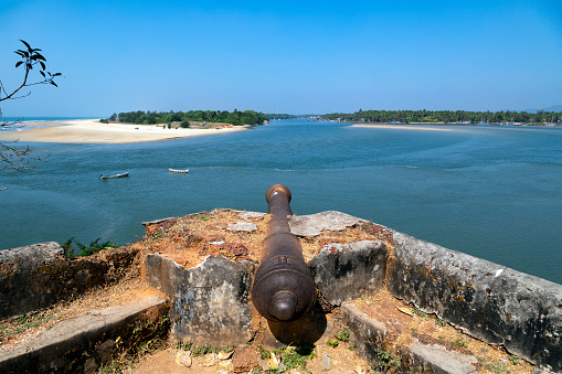 This photograph is taken from the vantage point of Batul Fort in Goa, India, offering a panoramic view that captures the essence of this coastal state. The fort, a historic structure overlooking the Arabian Sea, provides a unique perspective of the juxtaposition between the ancient and the modern, with fishing boats and water sports activities often visible in the distance. The image encapsulates the scenic beauty, rich history, and cultural diversity that make Goa a captivating travel destination.