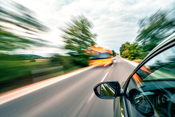 istock A car is driving on the highway, the environment is blurred. A bus is approaching. 1726393359