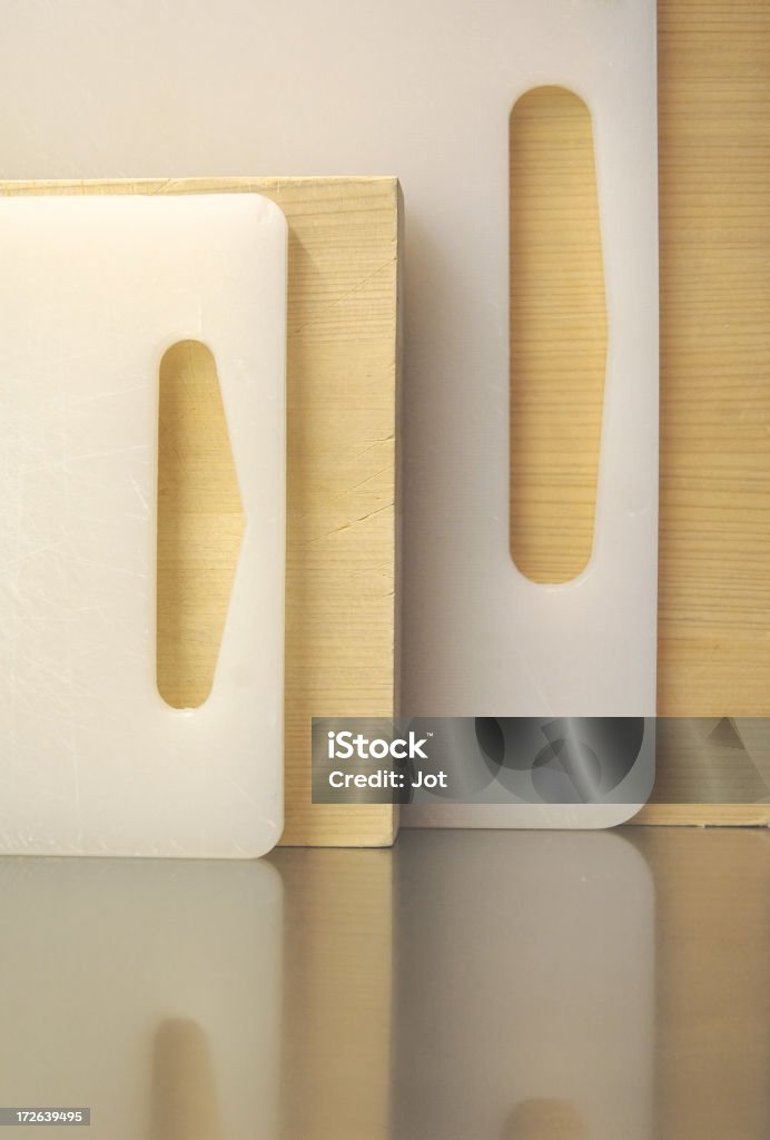 Kitchen - Chopping Boards Alternate cedar and plastic HDPE chopping boards on a stainless worktop Bread Stock Photo