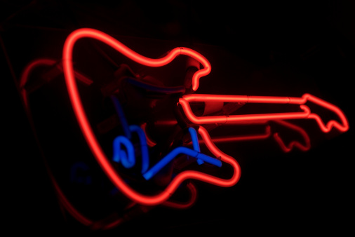 Electric guitar in bright red and blue neon