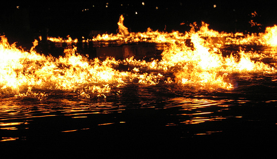 Fire burning on water at night.Other Night Images: