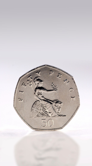 A British fifty pence piece. Showing the goddess Britannia with a lion.