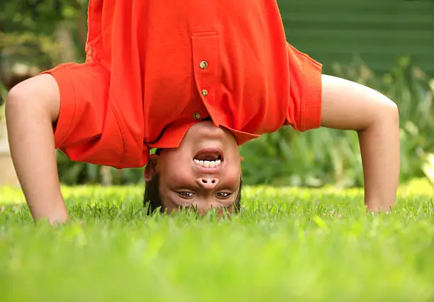 Photo of Primary aged schoolboy doing a headstand