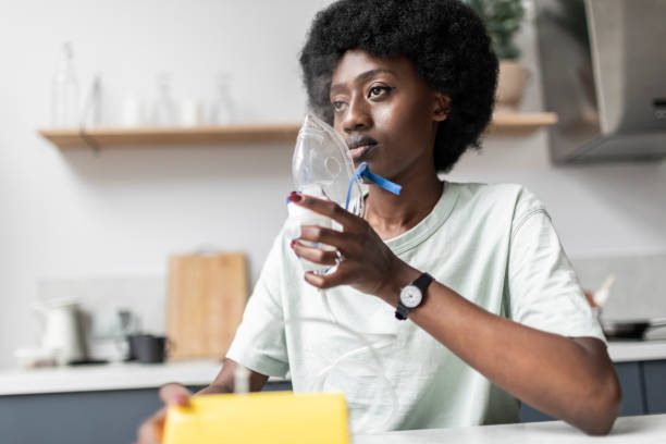 istock Young adult black woman suffering asthma using nebuliser 1726400375