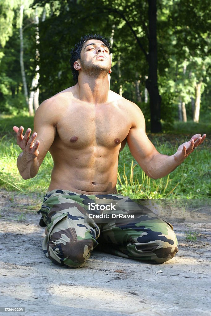 Praying 5 Palestinian soldier praying to god. Abdominal Muscle Stock Photo