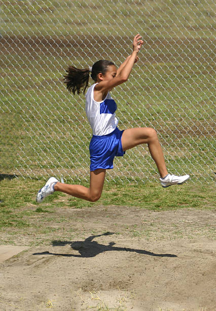 прыжок в длину - school sport high up long jump стоковые фото и изображения