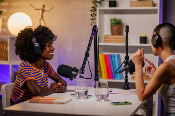 istock Two happy content creators are making a podcast 1726405279