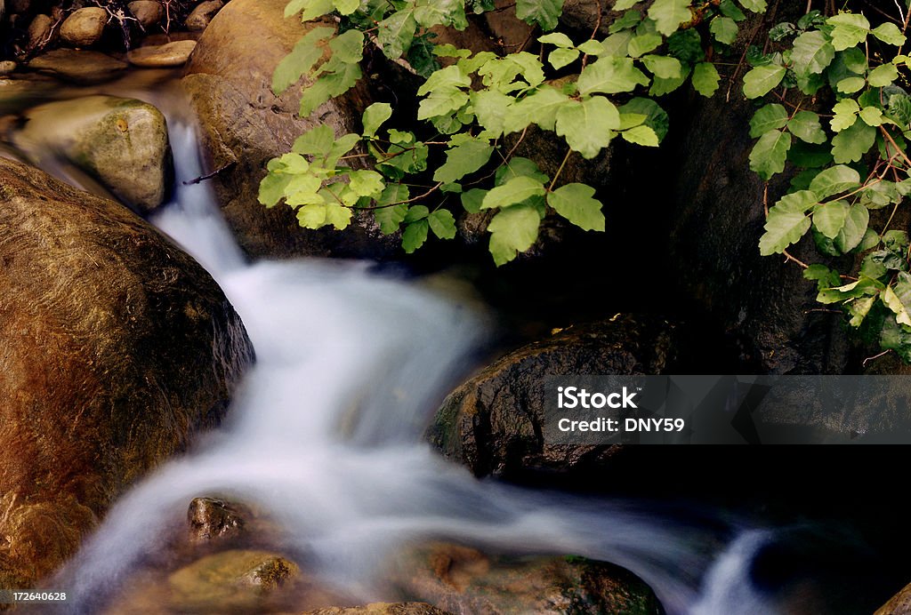 Babbling Brook Waterfall Small waterfall along a babbling brook. Bubble Stock Photo