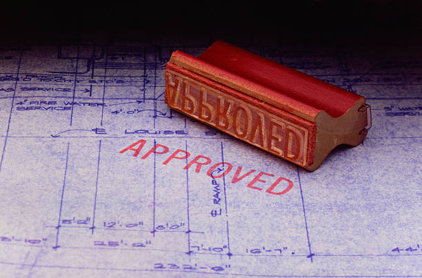 Approved Approval stamp sitting on set of blueprints Bureaucracy stock pictures, royalty-free photos & images