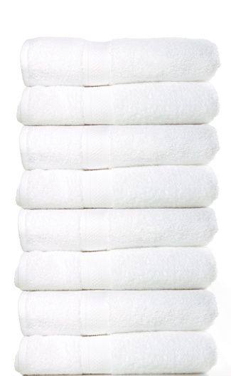 A stack of white towels on a white background.