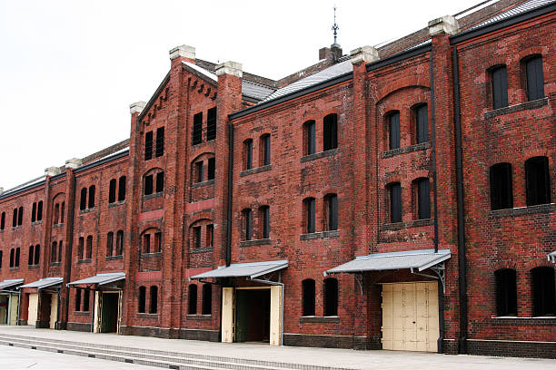 istock Three story old red brick warehouse with black windows 172641392