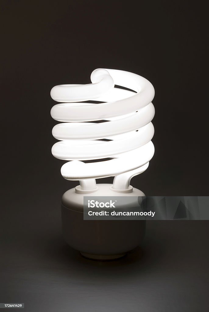 Compact fluorescent lighbulb (CFL) against dark background Abstract Stock Photo