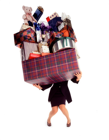 Woman balancing gifts purchased for holidays,birthday, or during shopping spree-isolated from backround.
