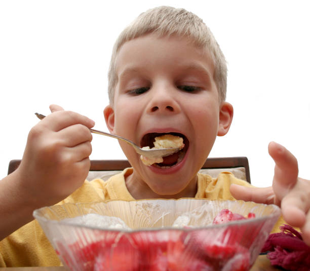 istock Boy Enjoying Ice Cream and Strawberries 172641643