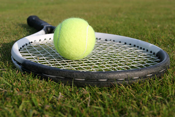 Tennis Tennis racquet and ball on grass wimbledon stock pictures, royalty-free photos & images