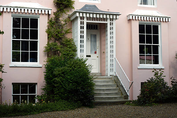 front porch on yellow home with white columns, steps leading up to door with white door and brass kickplate, taken with Canon 5D Mark II digital camera