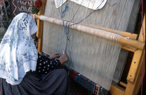 Woman weaving a carpet in Cappadocia Anatolia Turkey
