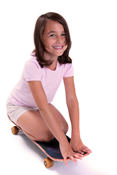 スケートの女の子 - kneeling skateboarding skateboard vertical ストックフォトと画像