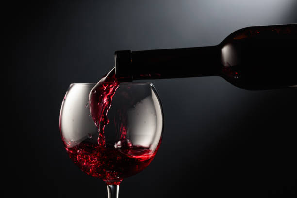 istock Pouring red wine into a wine glass. 1726431110