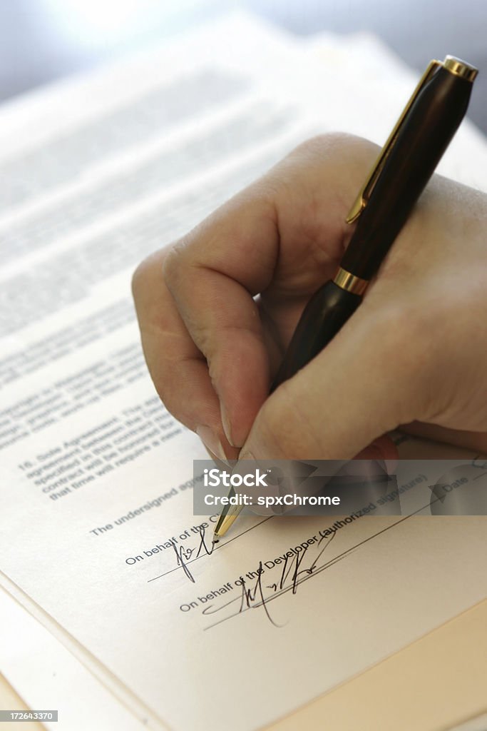 Signing Contract Shallow focus on signature. Contract Stock Photo