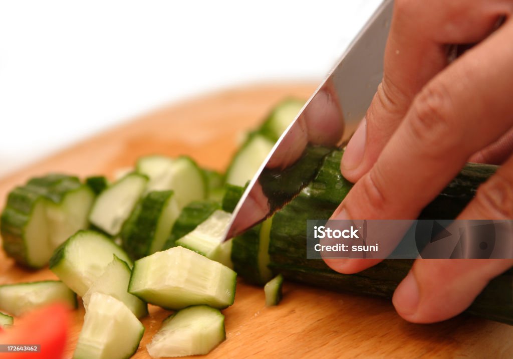 Chopping vegatables Chopping vegatables with a knife. Business Stock Photo