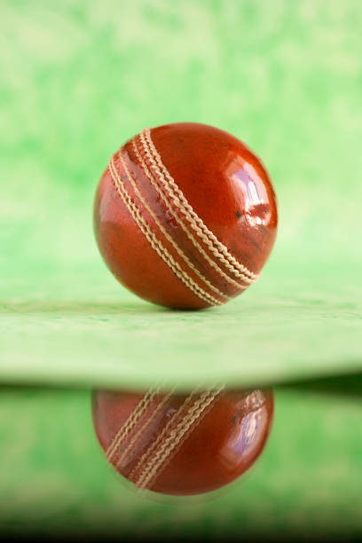 Indian boy in cricket uniform and wearing keeper gloves with hold leather ball. and doing practice. outdoor shoot. copy space.