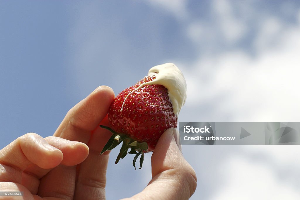 Strawberry and cream A strawberry covered in cream against the sky Strawberry Stock Photo