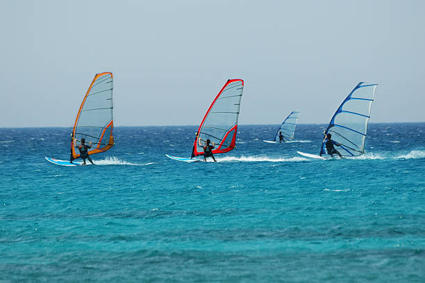 wind surf race four wind surf are racing windsurfing stock pictures, royalty-free photos & images