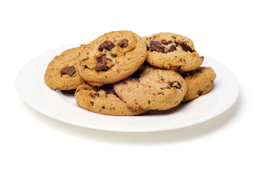 Plate of chocolate chip cookies on white with clipping path.