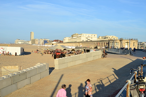 Ostend, West-Flanders, Belgium - October 1, 2023: high angle view on people walking, cycling on the King Boudewijn promenade in Ostend on a hot sunny Sunday
