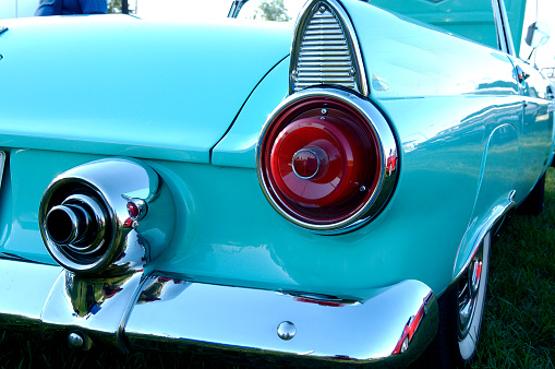Detailed shot of tailight and bumper of a 1950's classic American car.