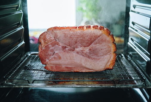 Pork ham in thin slices in a vacuum package on the table. Meat sliced carbonate in a package for long-term storage